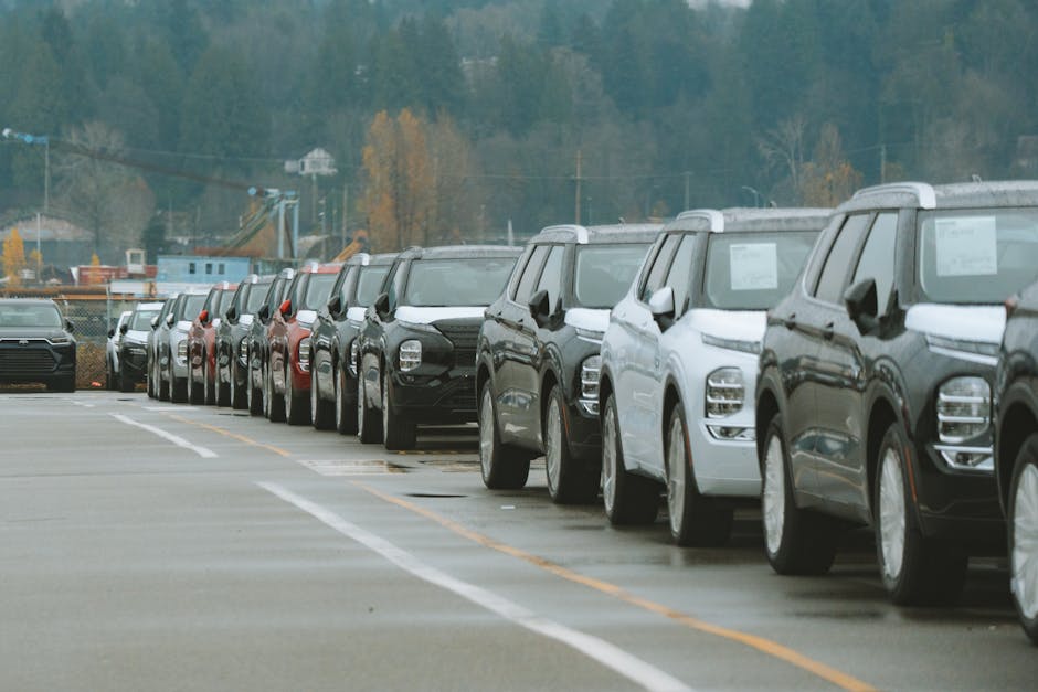A line of new SUVs parked in an outdoor dealership lot, ready for sale